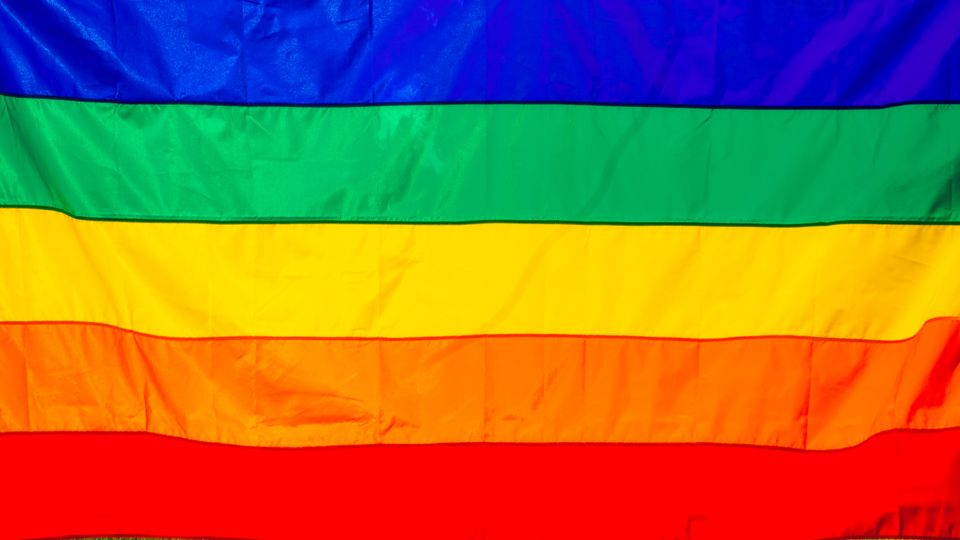 Bright rainbow flag featuring vivid colors representing LGBT pride and diversity.