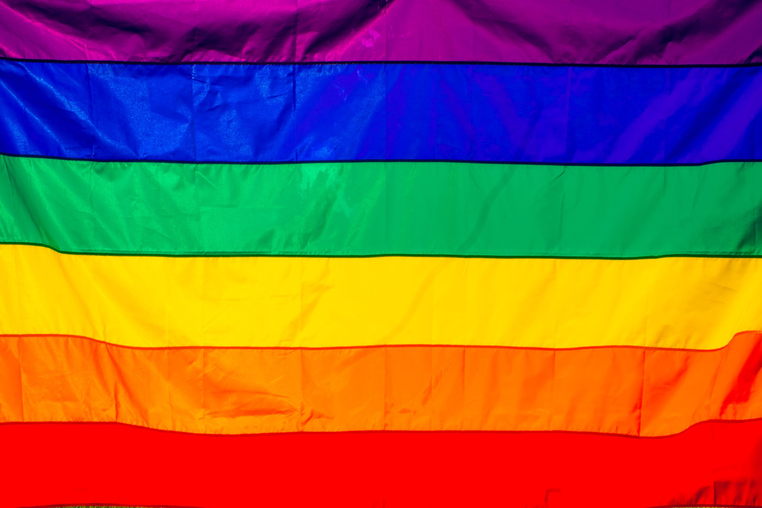 Bright rainbow flag featuring vivid colors representing LGBT pride and diversity.